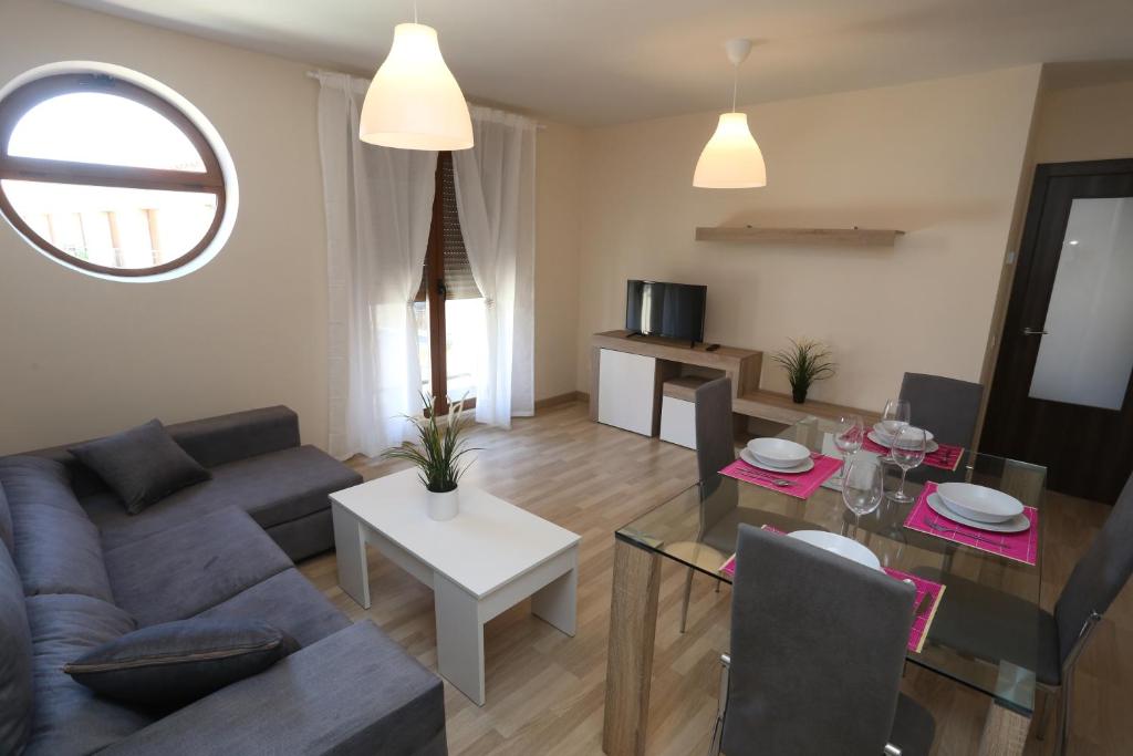 a living room with a couch and a table at Apartamento turisticos Puente Romano P3 2-A in Salamanca