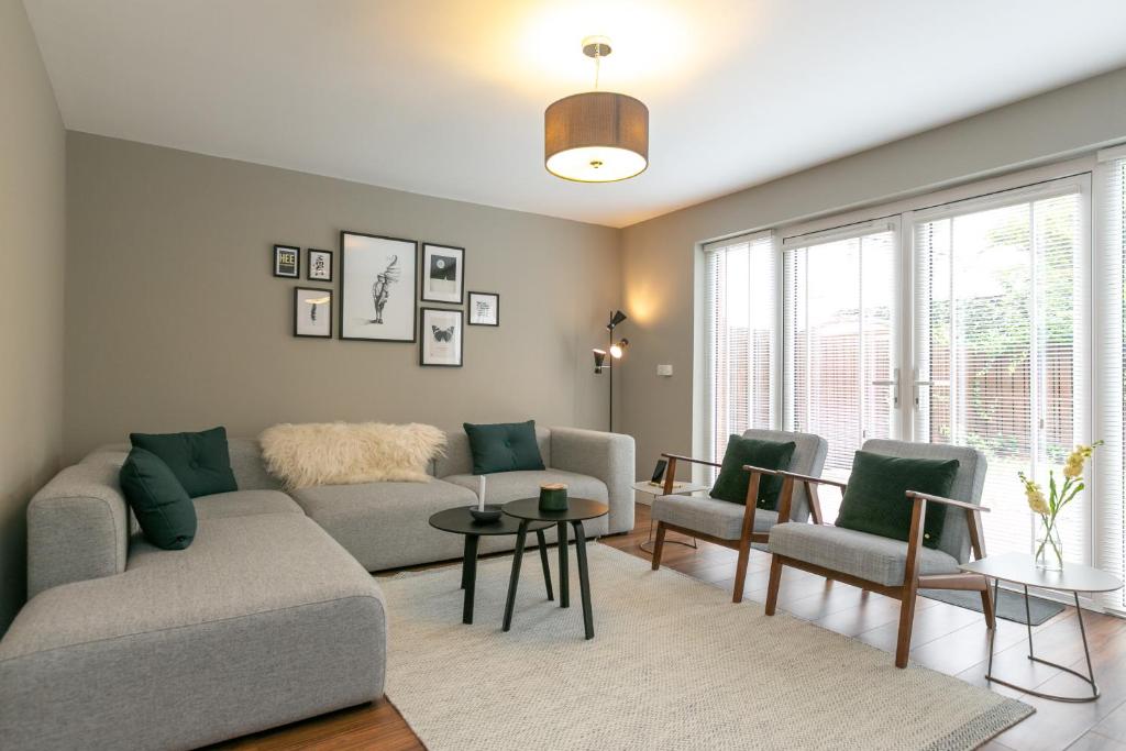a living room with a couch and chairs at The Perfect Stay Belfast in Belfast