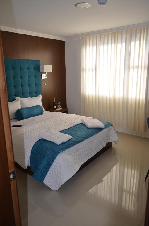 Postel nebo postele na pokoji v ubytování Hotel Gran Mariscal Quito