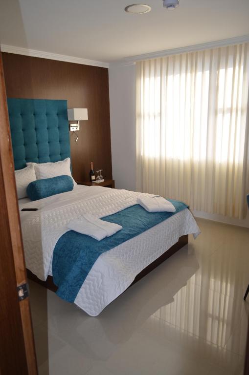 Postel nebo postele na pokoji v ubytování Hotel Gran Mariscal Quito