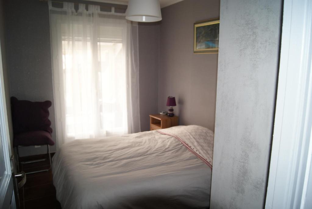 a small bedroom with a bed and a window at L'Albera in Argelès-sur-Mer