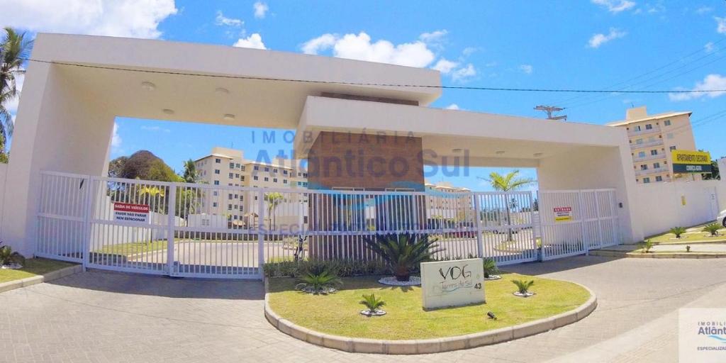 a large white building with a sign in front of it at Vog Torres do Sul in Ilhéus