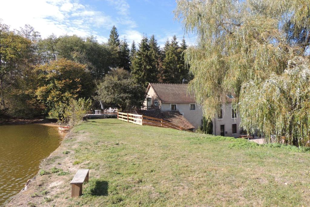 a house on a hill next to a river at Gîte Le Tournesac in Saint-Didier