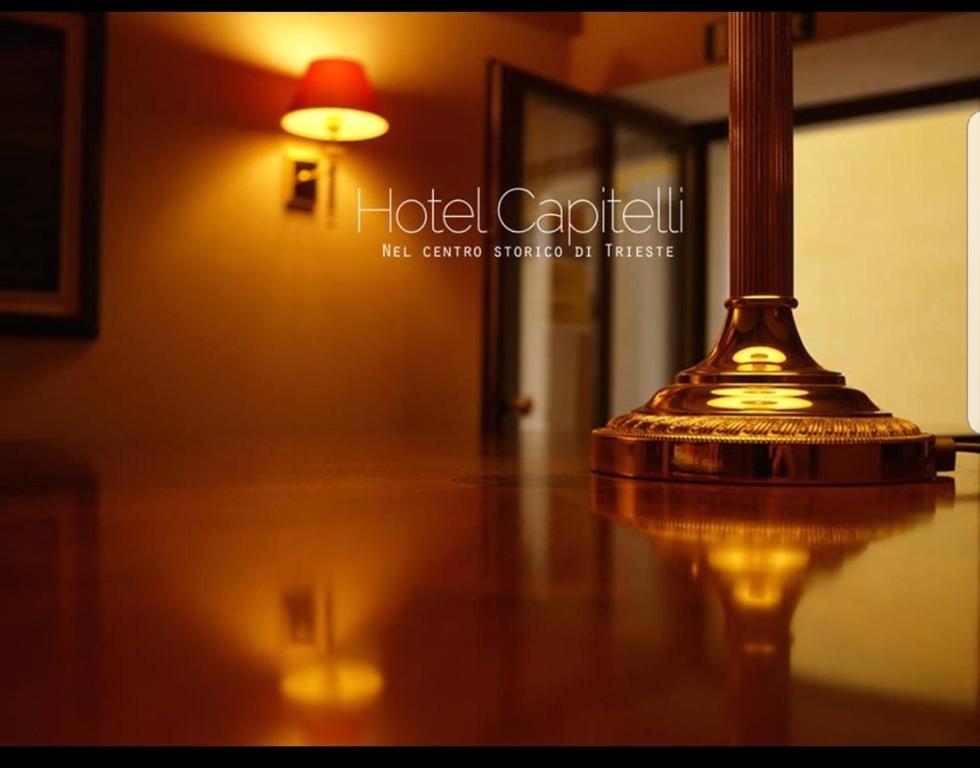 a lamp pole sitting on top of a wooden floor at Hotel capitelli in Trieste