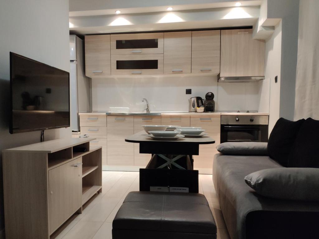 a kitchen with a couch and a table in a room at Standard Apartment by Prima Lodging in Thessaloniki
