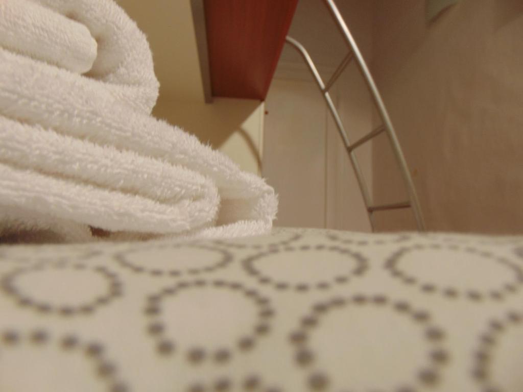 Posteľ alebo postele v izbe v ubytovaní Dante's Rooms