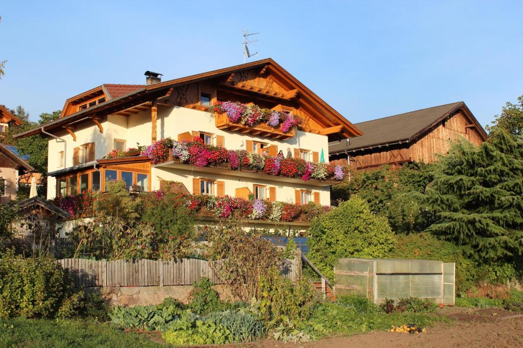 a house with flower boxes on the side of it at Kastnerhof in Meltina