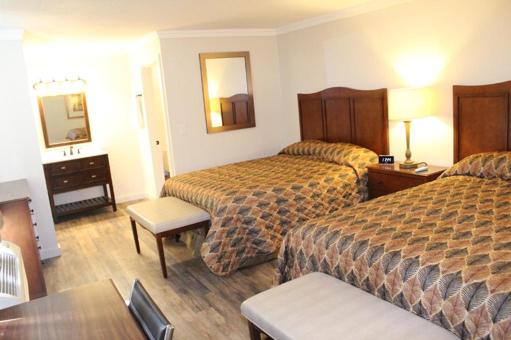 a hotel room with two beds and a table at The Northern Inn in Redway