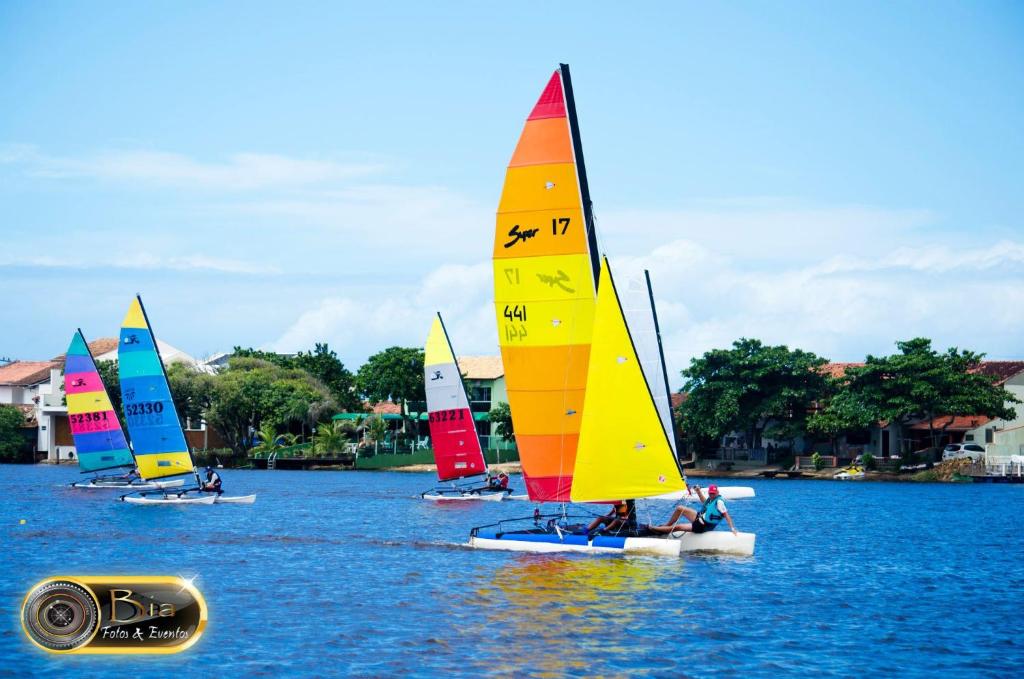 a group of sailboats on a body of water at Pousada Kanaxuê in Barra Velha