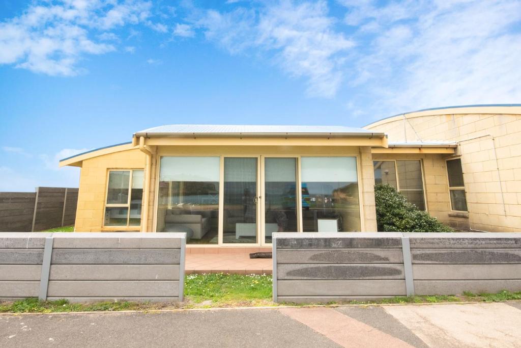a building with glass windows on the front of it at Bayview no 1 in Port Campbell