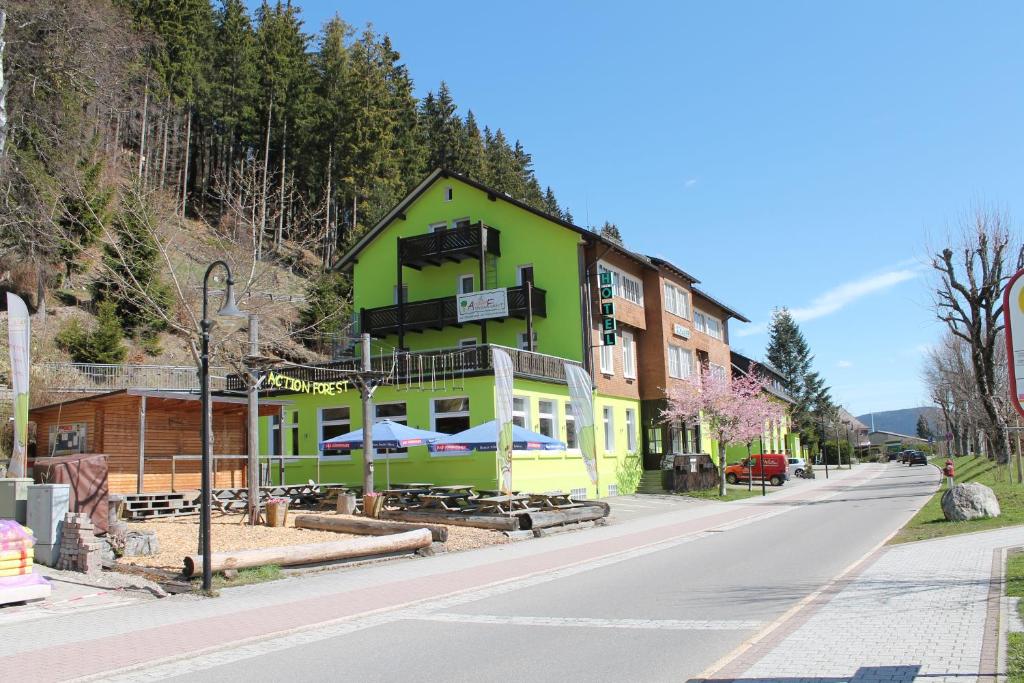 a green building on the side of a street at Action Forest Hotel Titisee - nähe Badeparadies in Titisee-Neustadt