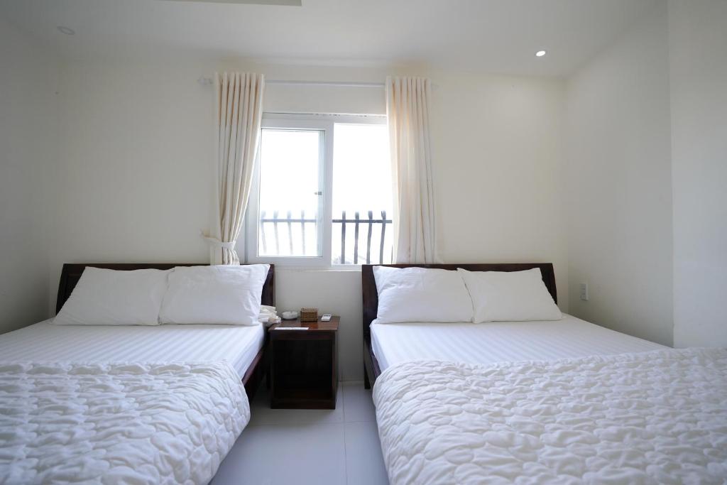 En eller flere senge i et værelse på Thanh Sang Guesthouse