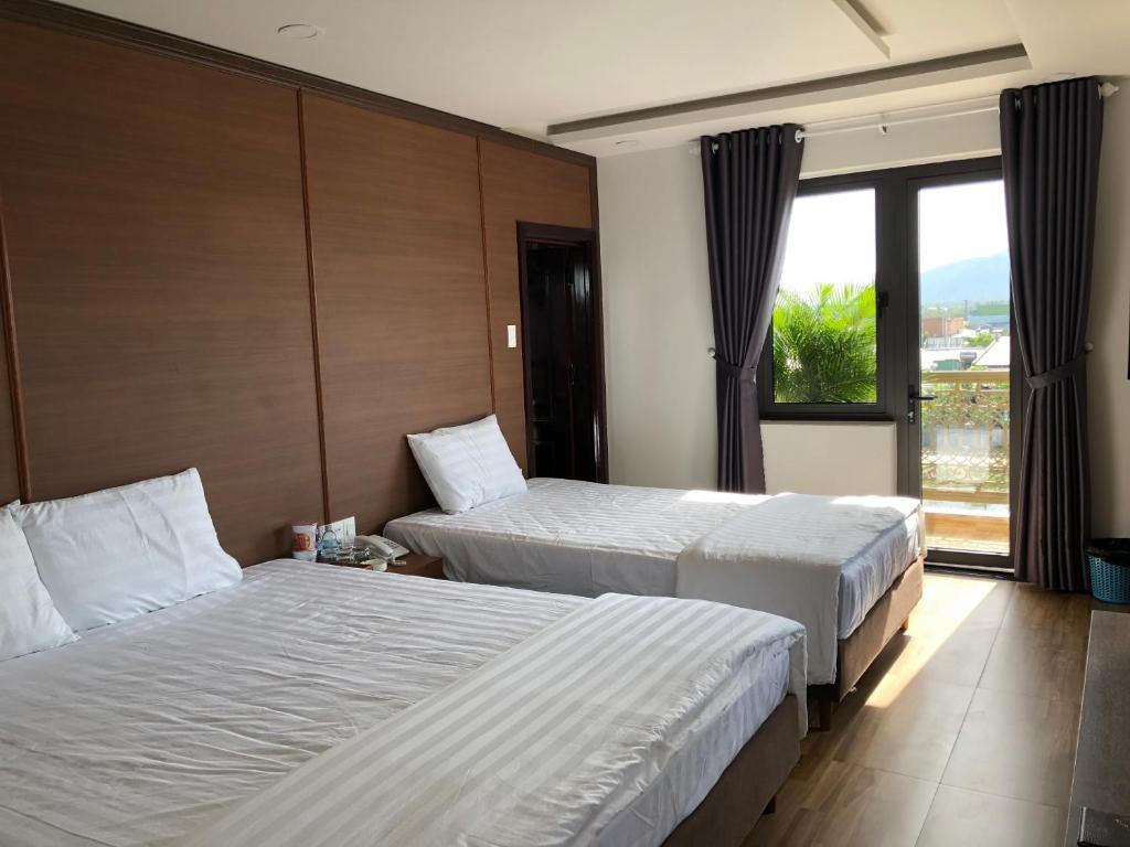 Uma cama ou camas num quarto em HOÀNG SA HOTEL