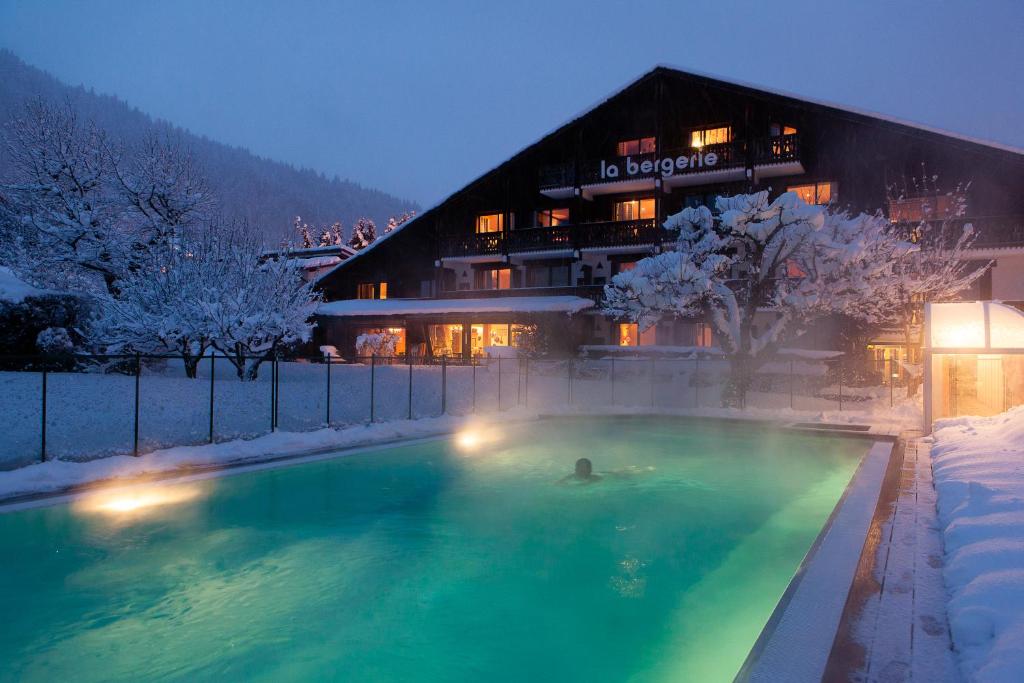 莫爾濟訥的住宿－Hôtel La Bergerie，在雪地游泳池游泳的人