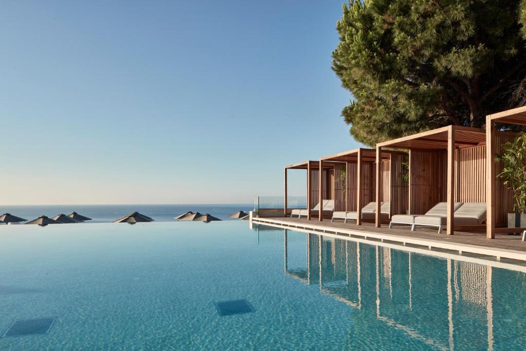 a swimming pool with a view of the ocean at Esperos Village Blue & Spa - Adults Only in Faliraki