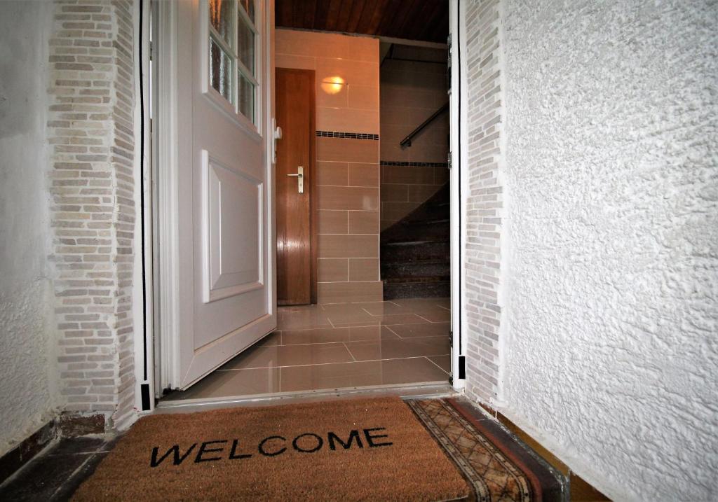 una alfombra de bienvenida frente a una puerta en Monteurhaus Burgberg - Giengen an der Brenz, en Burgberg