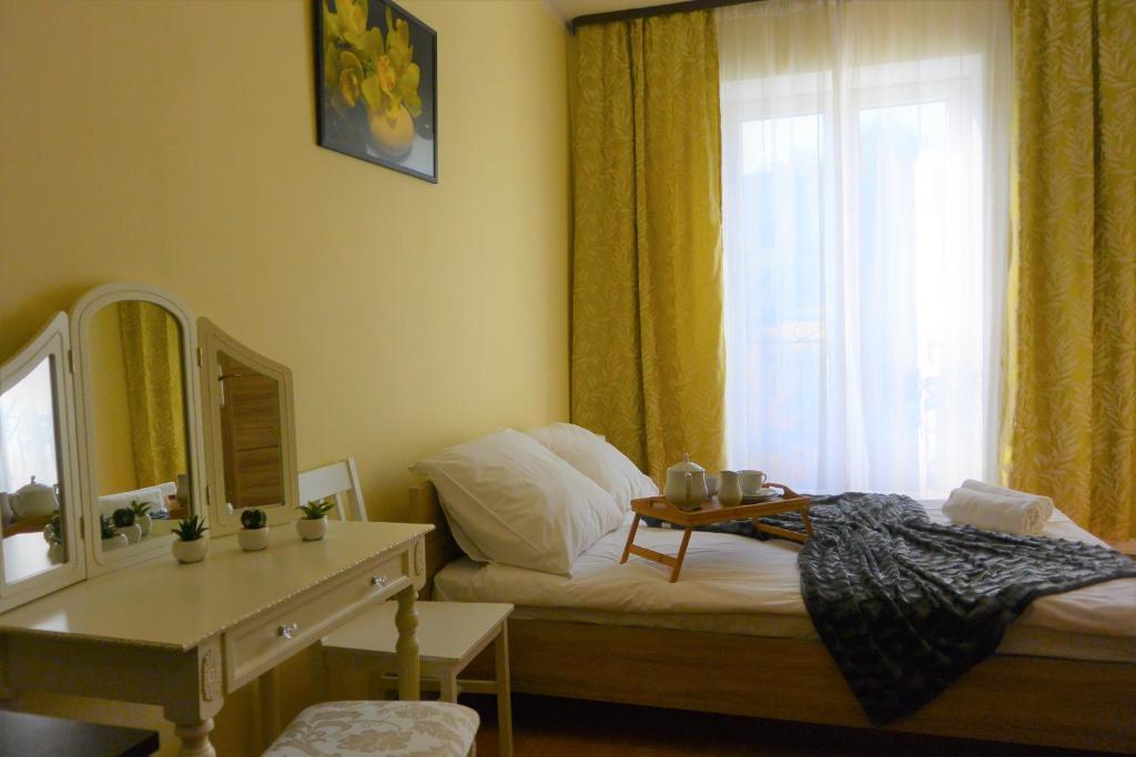 1 dormitorio con cama, espejo y ventana en Hostel DV Morski - z prywatnymi łazienkami, en Gdynia