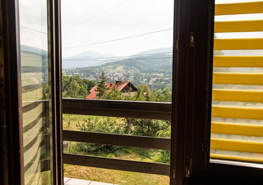 a window looking out at a view from a house at Cezar Naturyzm Bielsko-Biała in Bielsko-Biała