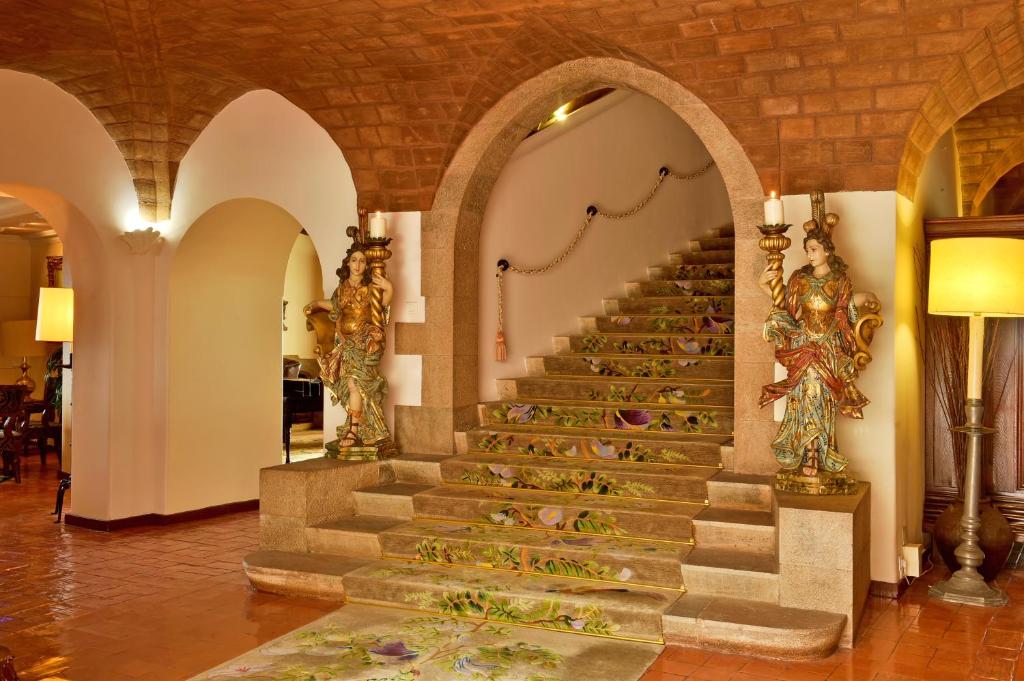 a staircase in a building with flowers on it at Hotel Fortaleza do Guincho Relais & Châteaux in Cascais