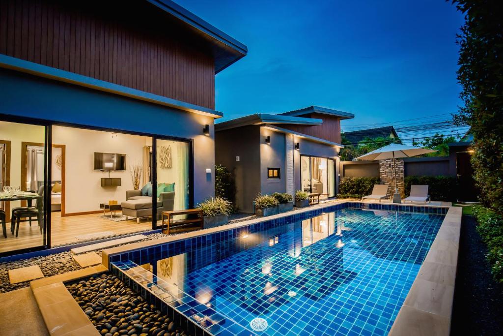 a swimming pool in the backyard of a house at The Sister Pool House in Bang Tao Beach