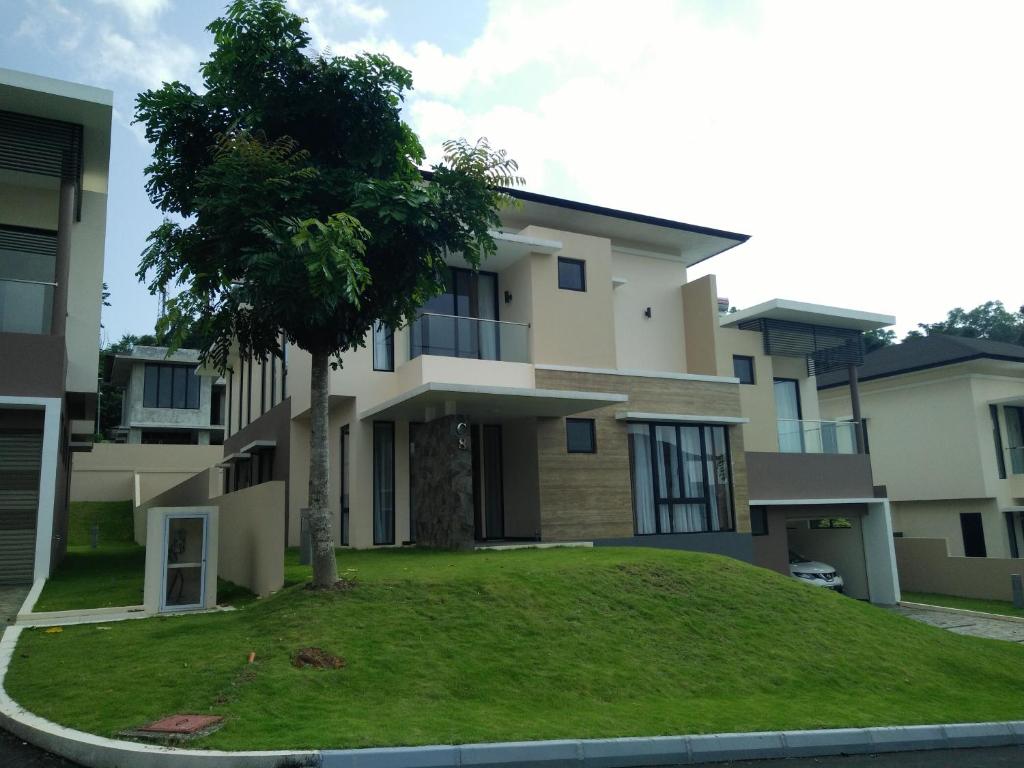 a house with a tree in front of it at SleepRest @ Nagoya Valley in Nagoya