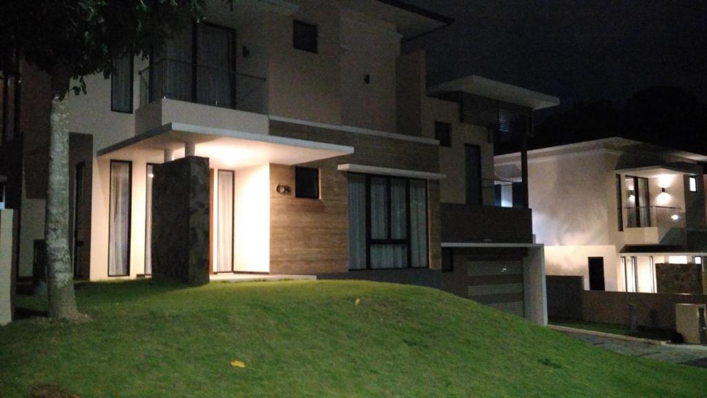 a house at night with a lawn in front of it at SleepRest @ Nagoya Valley in Nagoya
