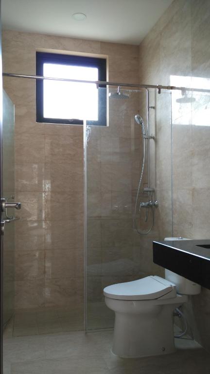 a bathroom with a glass shower with a toilet at SleepRest @ Nagoya Valley in Nagoya