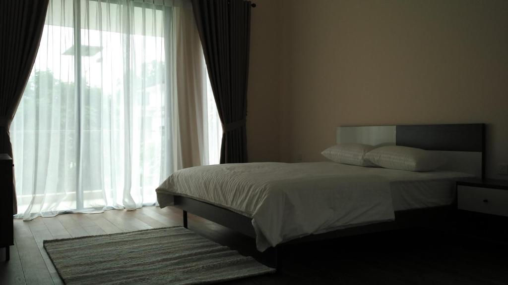 a bedroom with a bed and a large window at SleepRest @ Nagoya Valley in Nagoya