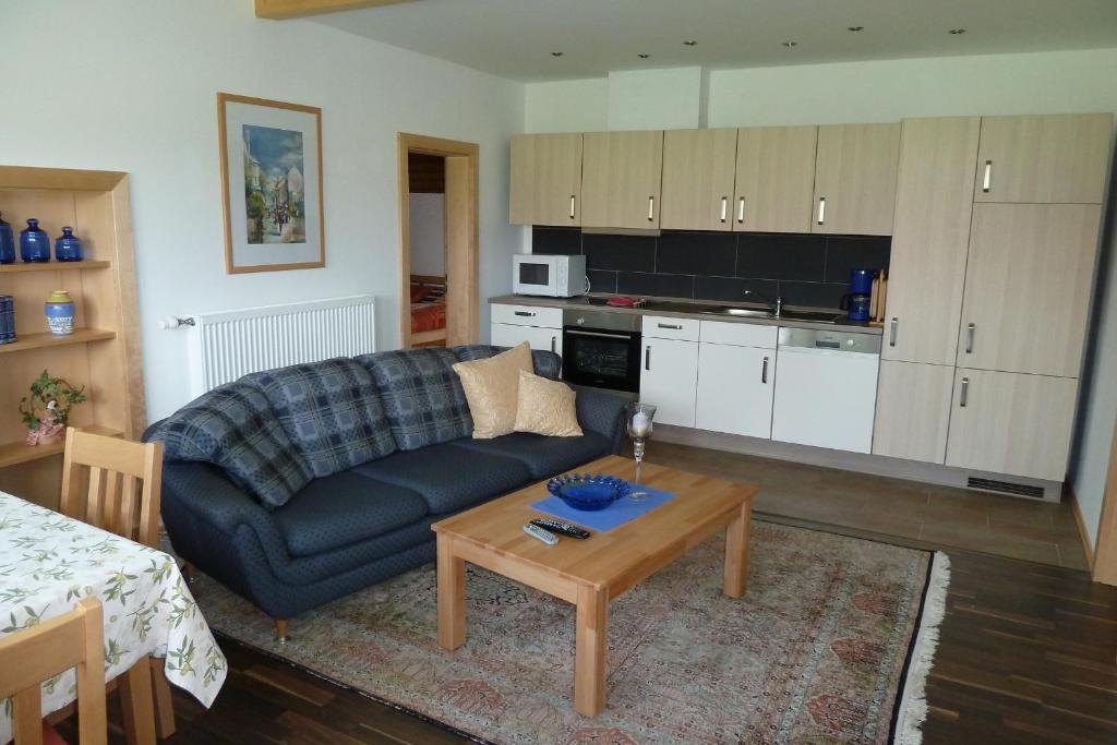 a living room with a couch and a table at Ferienwohnung Dachs in Zachenberg