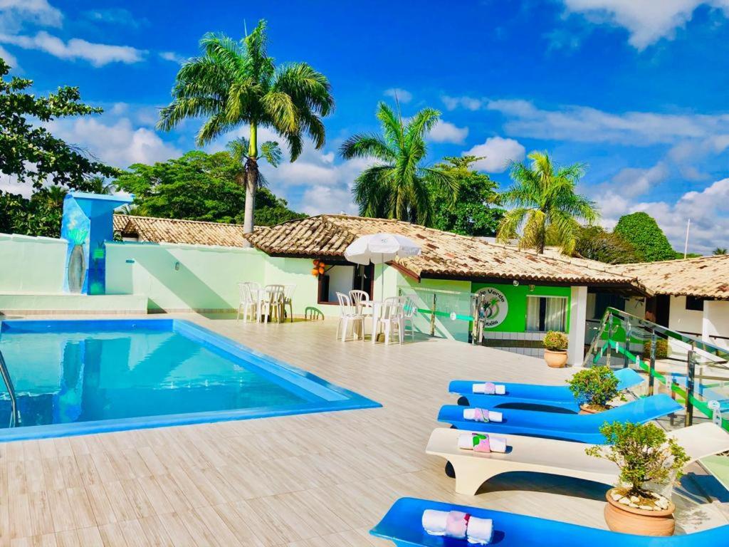 a villa with a swimming pool and a resort at Hotel Vale Verde in Porto Seguro