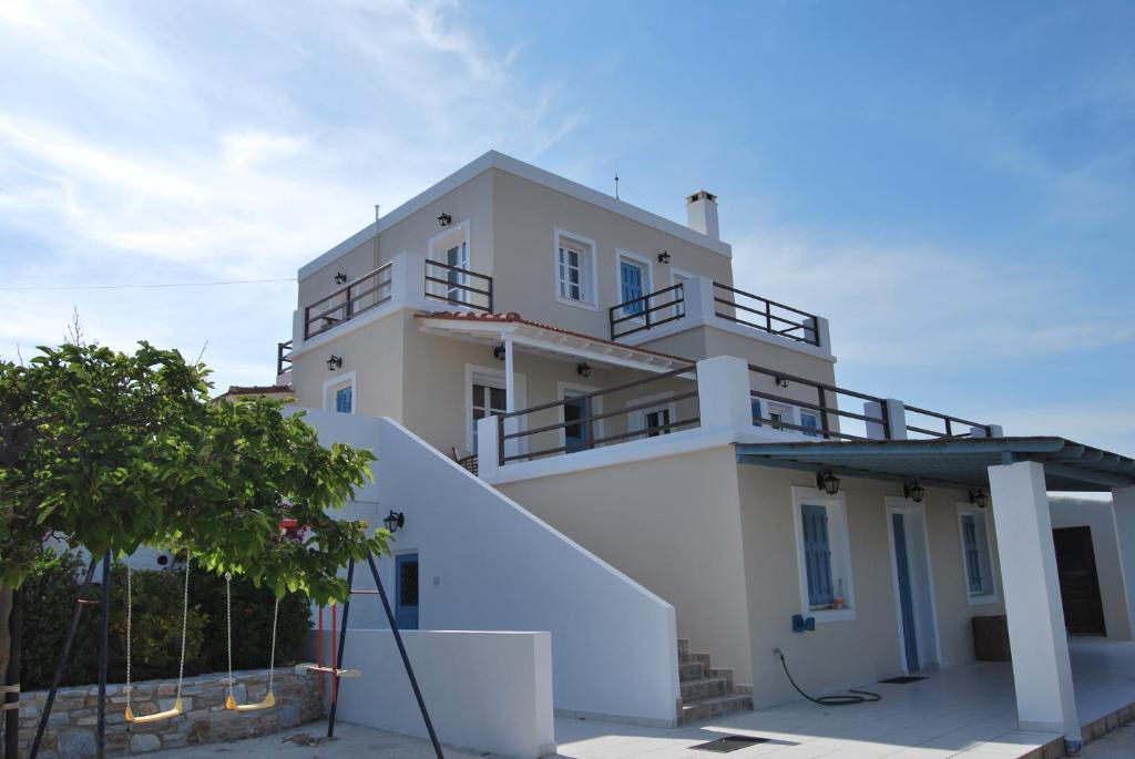 a white building with balconies on top of it at BAY VIEW HOUSE in Megas Gialos - Nites