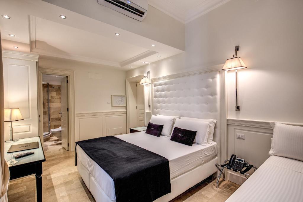 Postel nebo postele na pokoji v ubytování Hotel Domus Mea