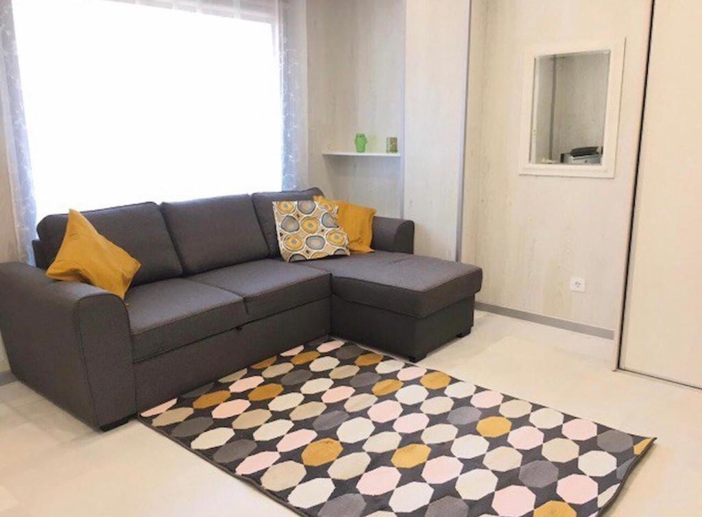 a living room with a couch and a rug at Pueblo Canario Loft In Las Americas in Playa Fañabe