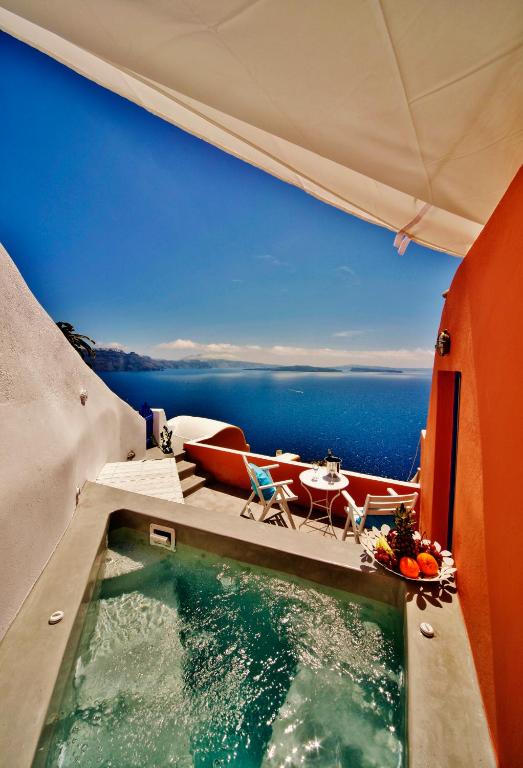 a swimming pool with a view of the ocean at Chroma Suites in Oia