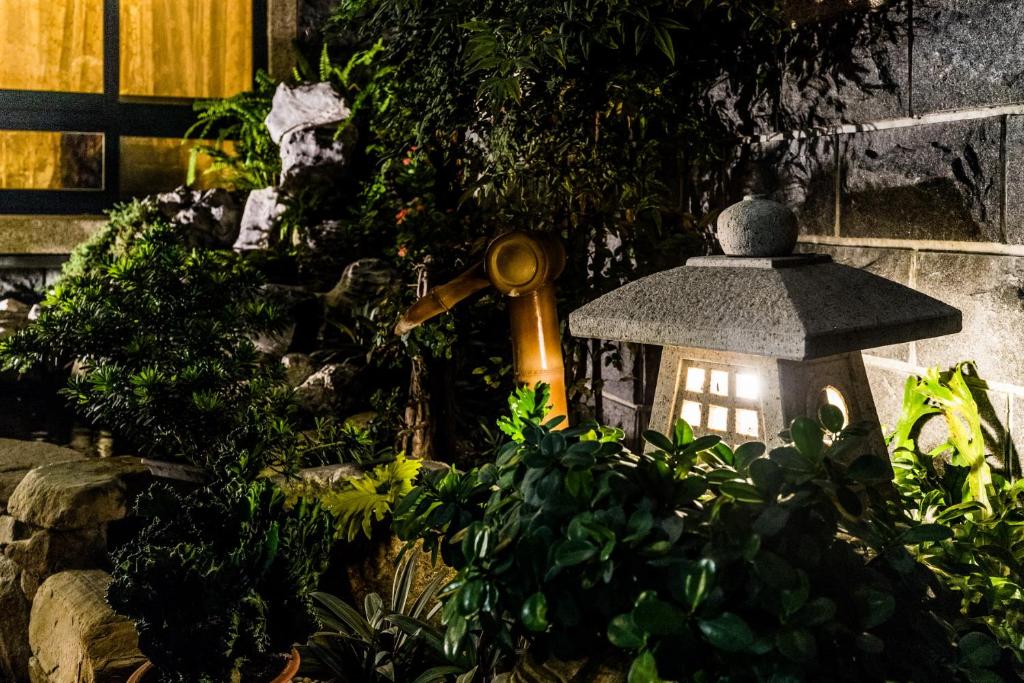 a light in a garden with a plant at Qing Jing Ze Bed &amp; Breakfast in Hualien City