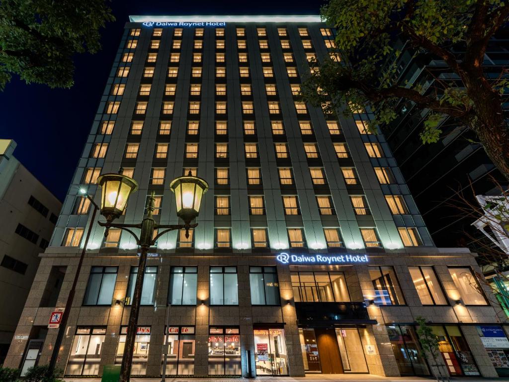 a building with a street light in front of it at Daiwa Roynet Hotel Himeji in Himeji