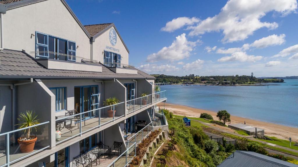 a building with a view of a body of water at Blue Pacific Apartments in Paihia