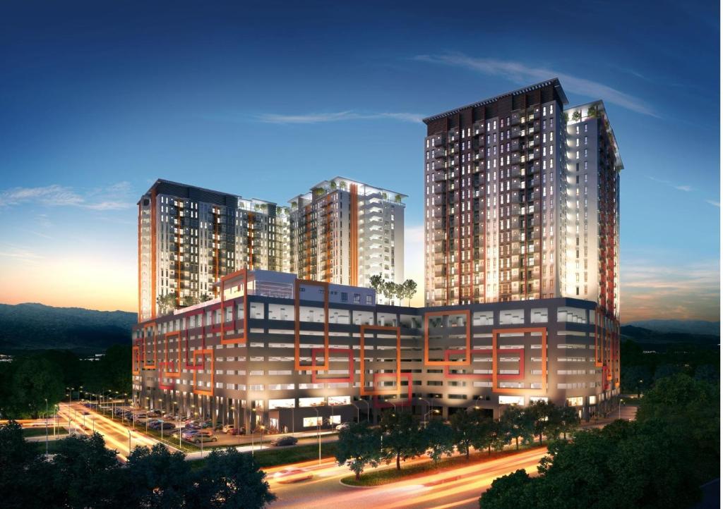 two tall buildings in a city at night at HZ Homestay @Ascotte Boulevard in Semenyih