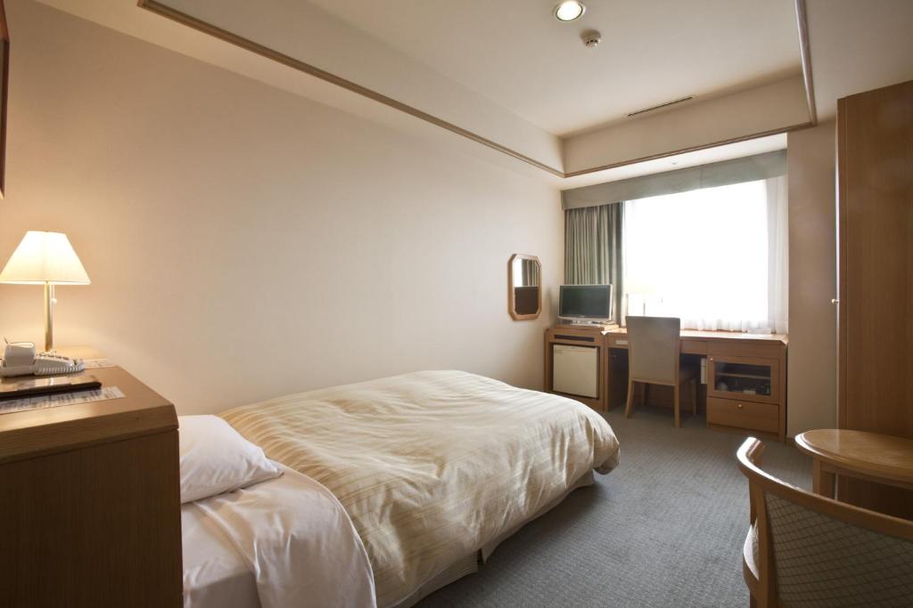 Postel nebo postele na pokoji v ubytování Hotel Mielparque Nagoya