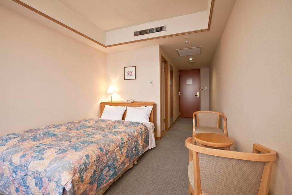 Postel nebo postele na pokoji v ubytování Hotel Mielparque Nagoya
