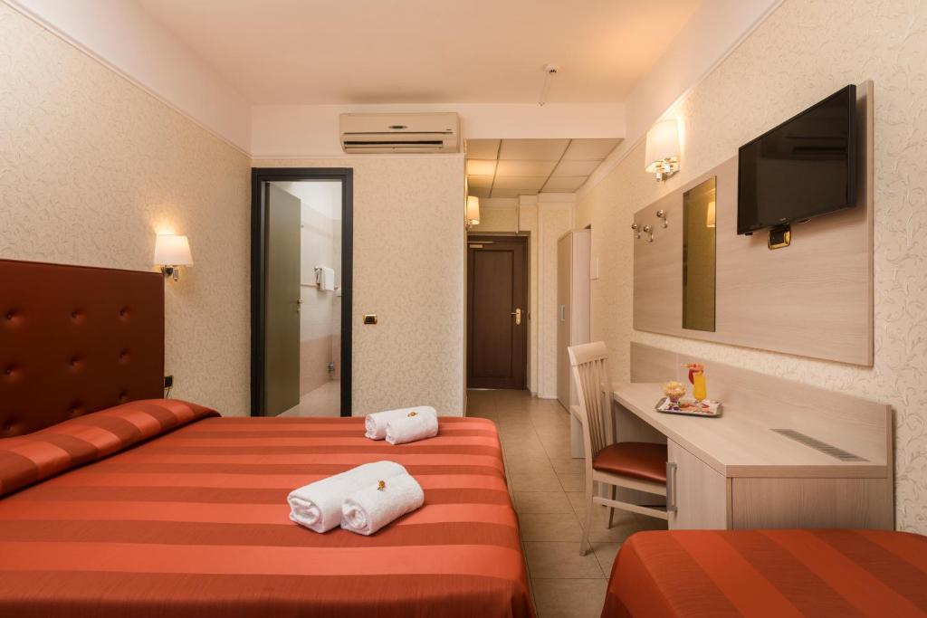Postel nebo postele na pokoji v ubytování Hotel Villa Rosa