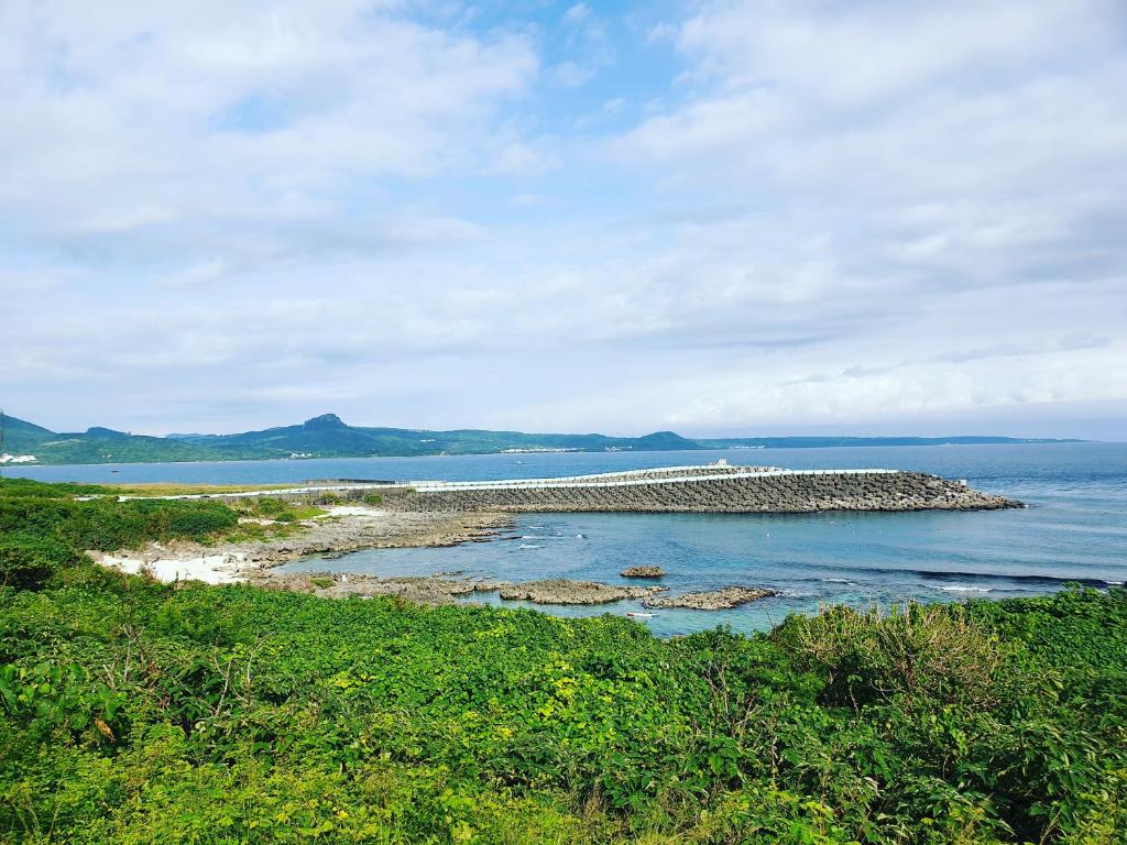a bridge over a body of water with green plants at Kenting Garden Homestay in Kenting