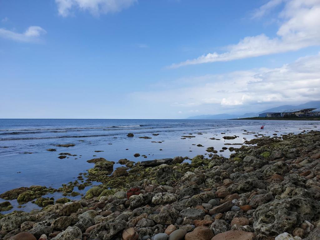 a large group of rocks on the shore of the ocean at Kenting Garden Homestay in Kenting