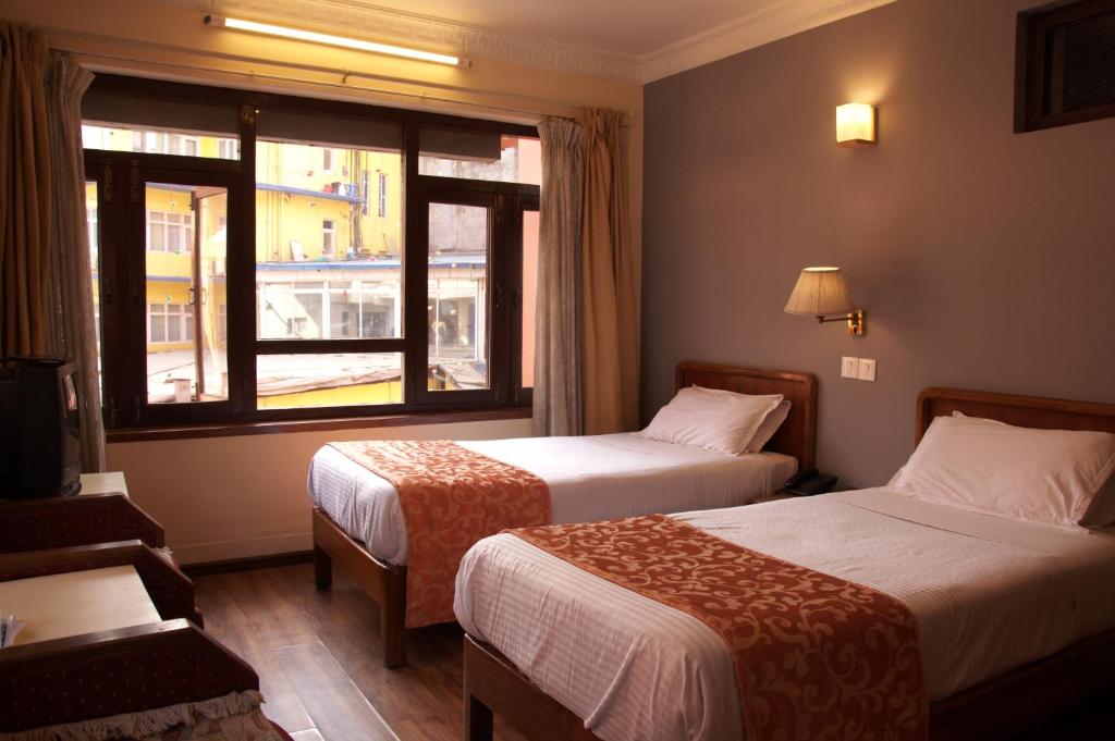Postel nebo postele na pokoji v ubytování Tibet Guest House