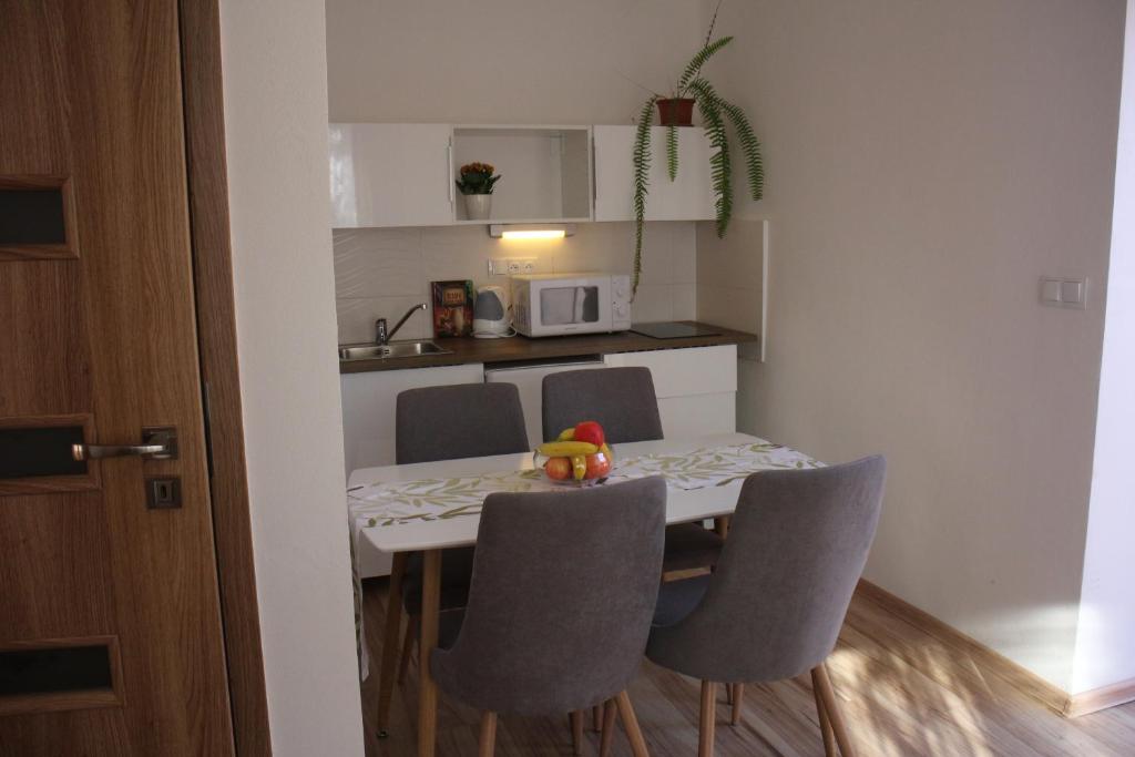 a small kitchen with a table and chairs in a room at Apartmánový dom Mária in Banská Štiavnica