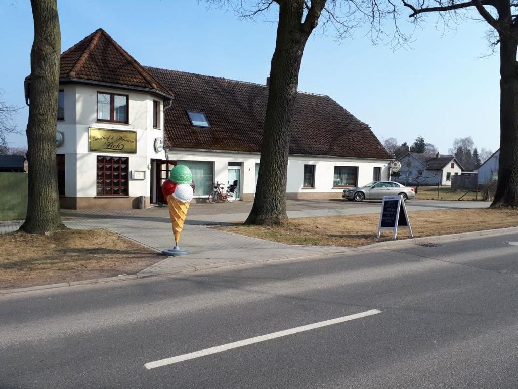 a person standing on the side of a street at Gasthof und Pension Zick in Eggesin