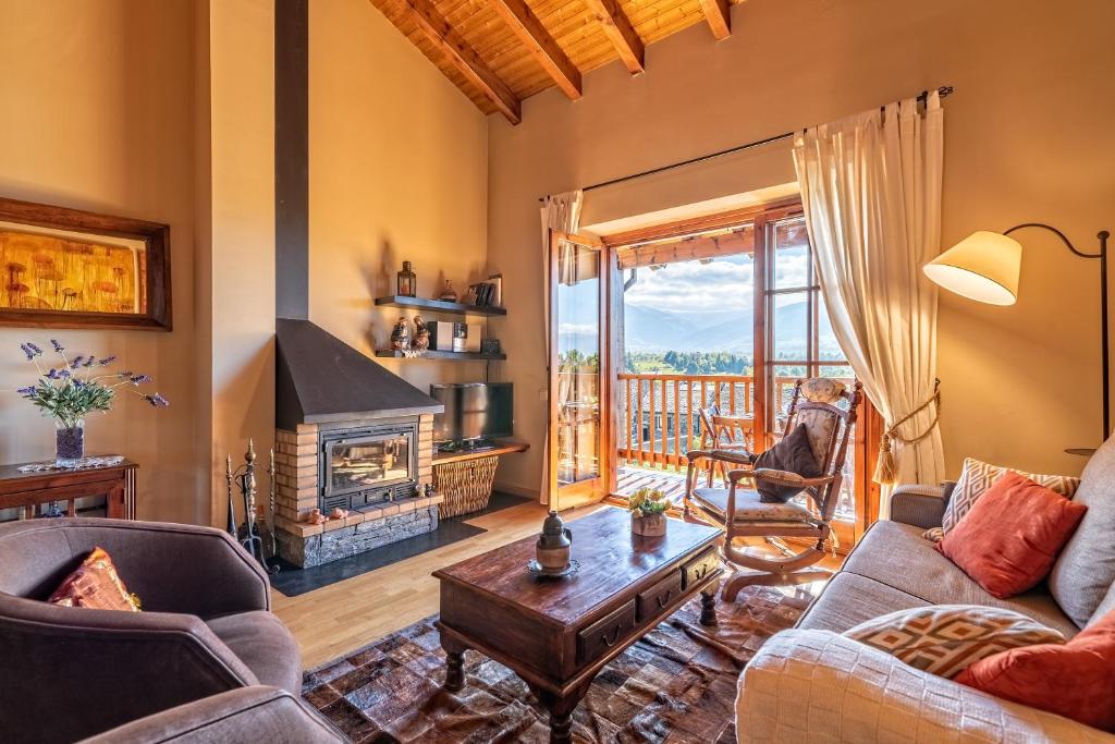 a living room with a couch and a fireplace at Casa con encanto en la Cerdaña Francesa in Estavar