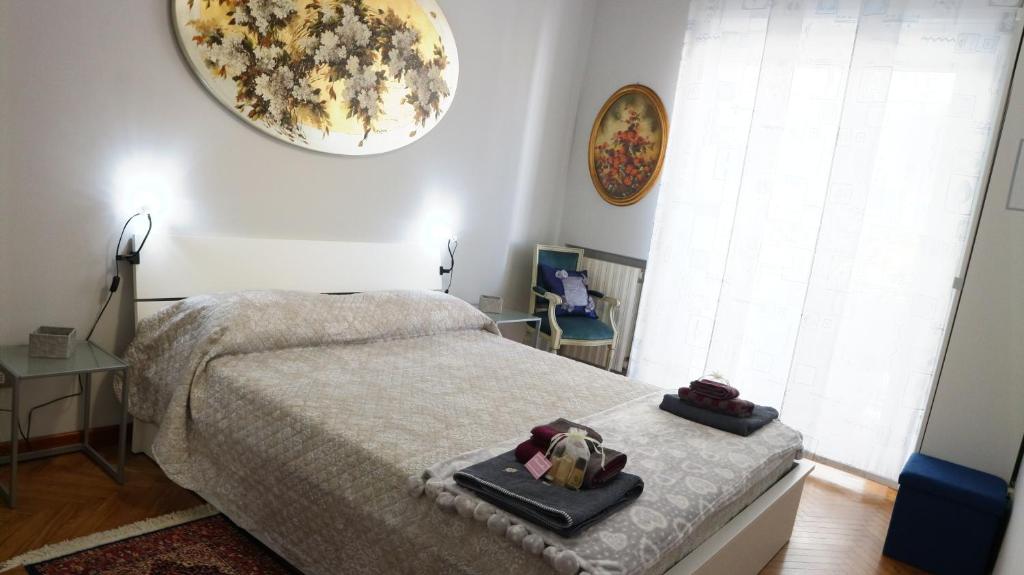 a bedroom with a bed with two trays on it at Affittacamere MammaMia in Sanremo