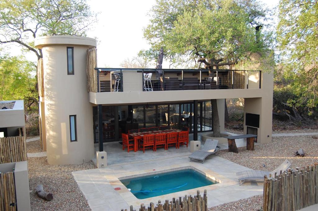 a large house with a swimming pool and a house at Ngalas Rest 101 in Hectorspruit