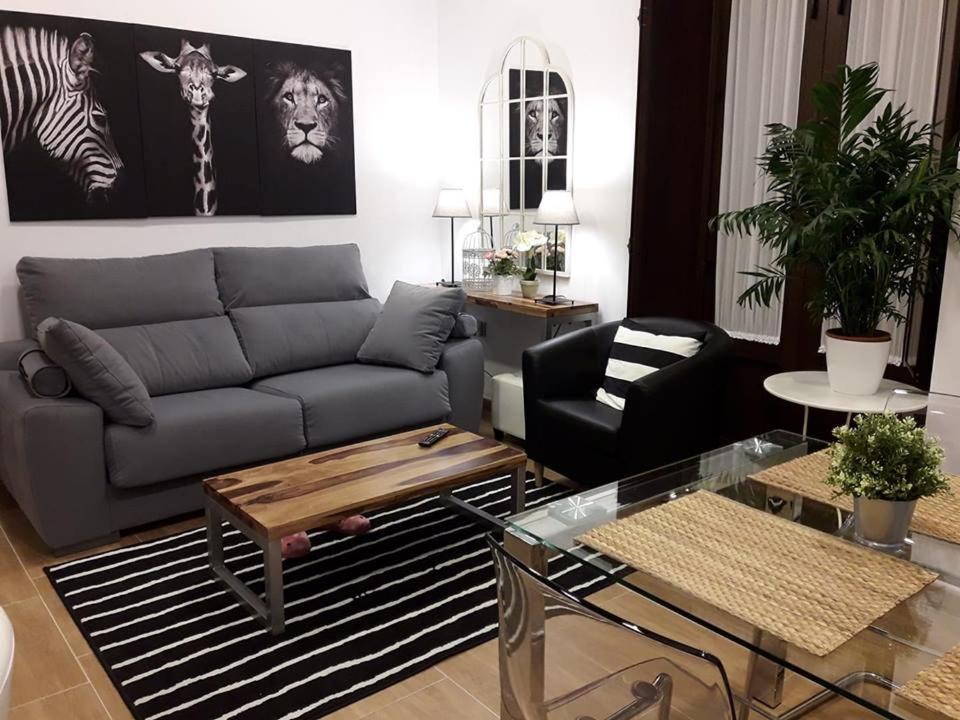 a living room with a couch and a table at Periodista Luca de Tena, lujo y confort en pleno centro in Huelva